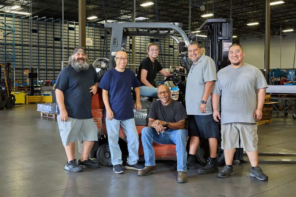 group of team members standing near forklift